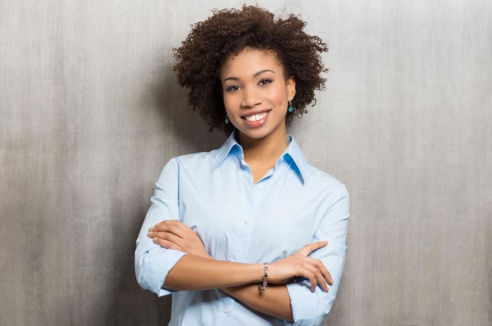 Woman crossing arms in a blue shirt