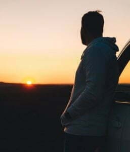 A man in an outpatient program looking at sunset