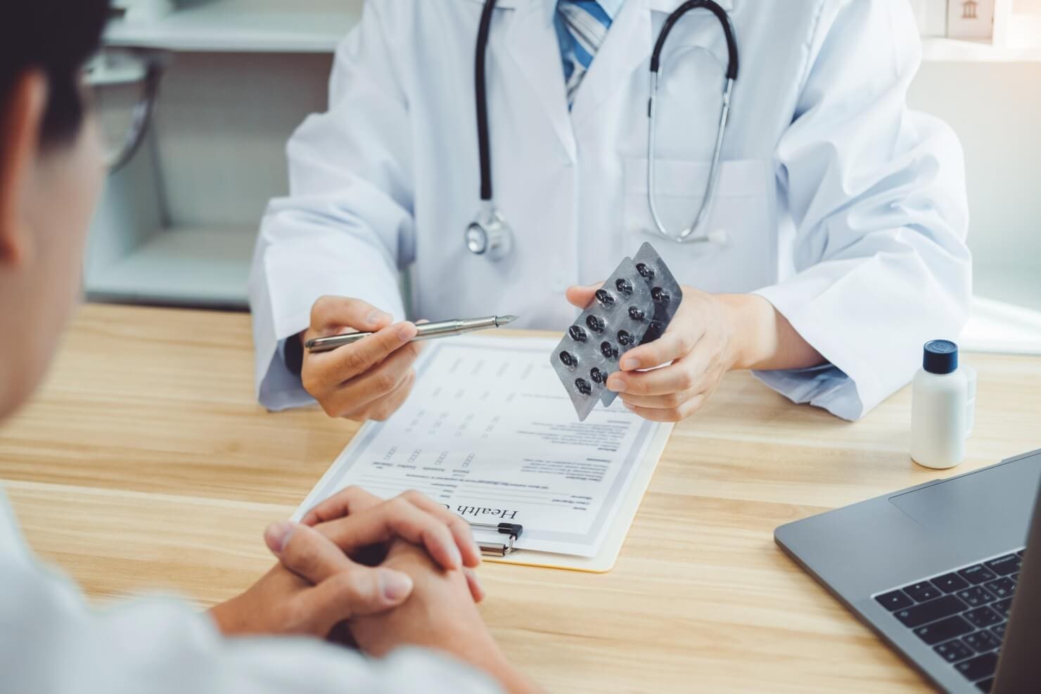 A doctor is talking to a patient in an outpatient program.