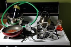 A men's only rehab facility equipped with a stove top, pots and pans for culinary therapy programs.