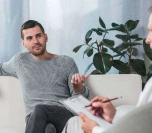 A man speaking to a therapist during a counseling session at a Chardon, Ohio rehab.